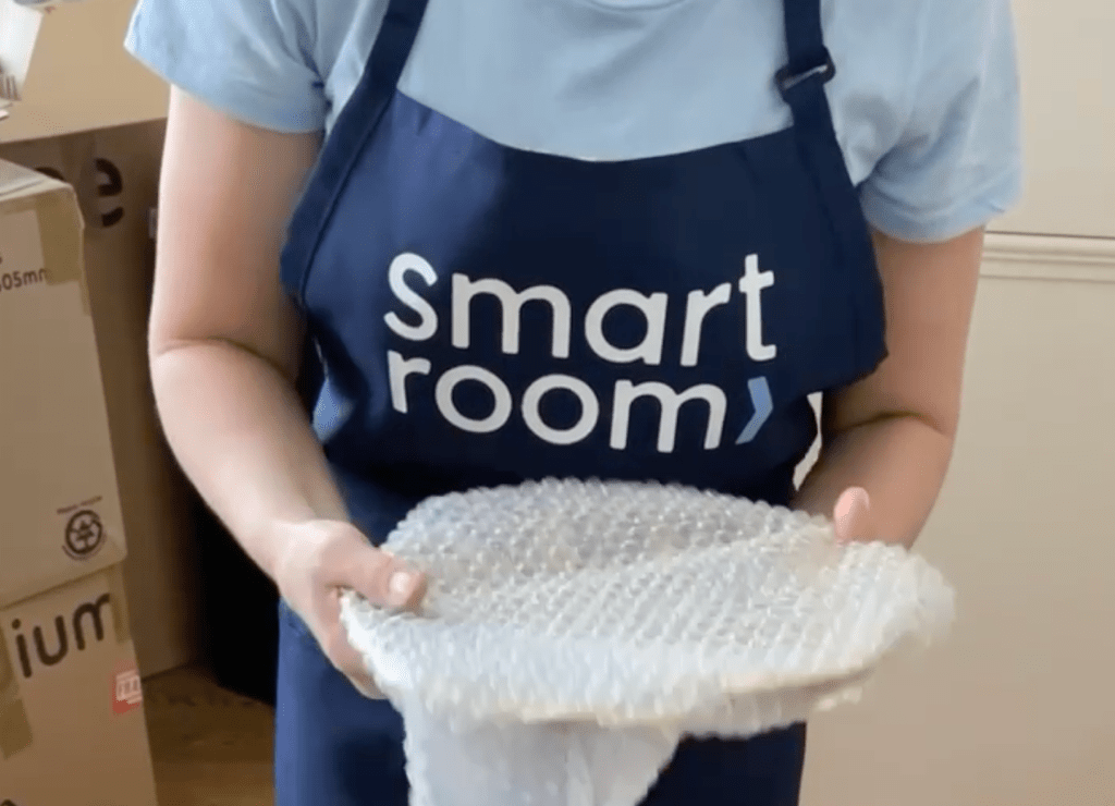 Person packing boxes for self storage in Bloomsbury, Central London, preparing for Smartroom collection